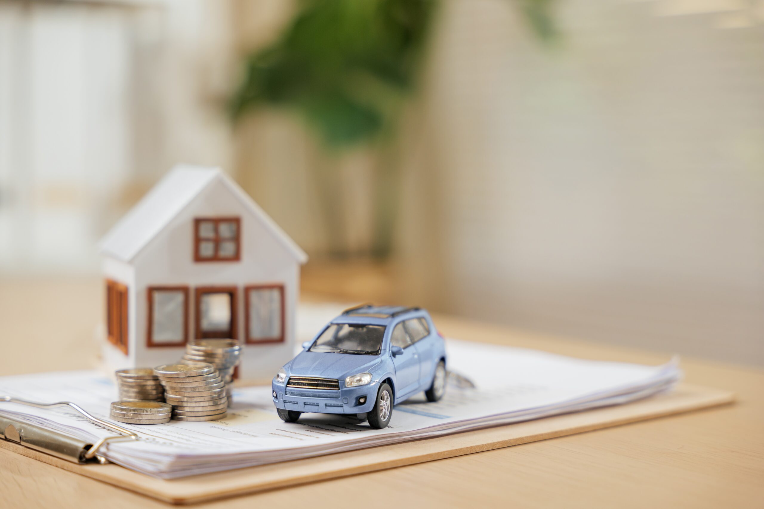House and car model with financial documents, estate planning and property trust advice